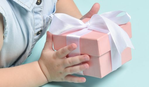A gesture with children's hands giving a gift.