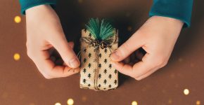 Male hands are packing a gift box