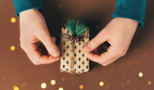 Male hands are packing a gift box