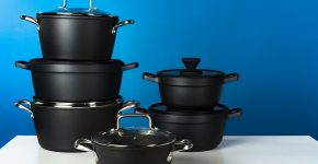 Set of black cookware against blue background