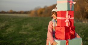 Woman carries New Year's gifts outdoors