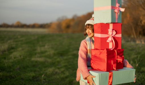 Woman carries New Year's gifts outdoors